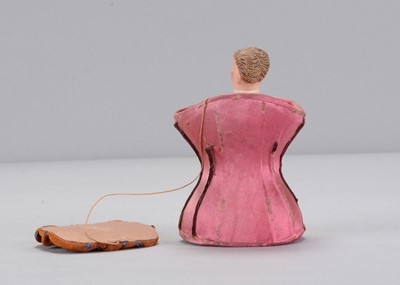 Lot 21 - A late 19th century novelty gentleman popping up from a pink silk corset