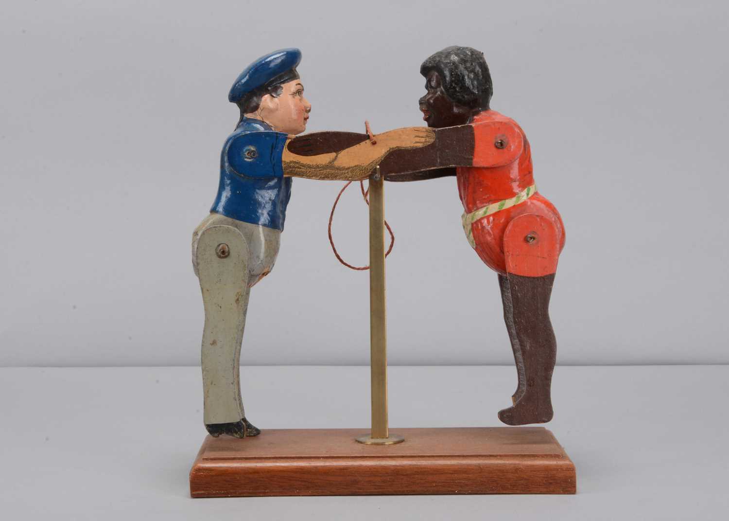 Lot 34 - An Albin Amende Sonneberg German navy sailor from the SMS Eber and black man wresting toy, circa 1888