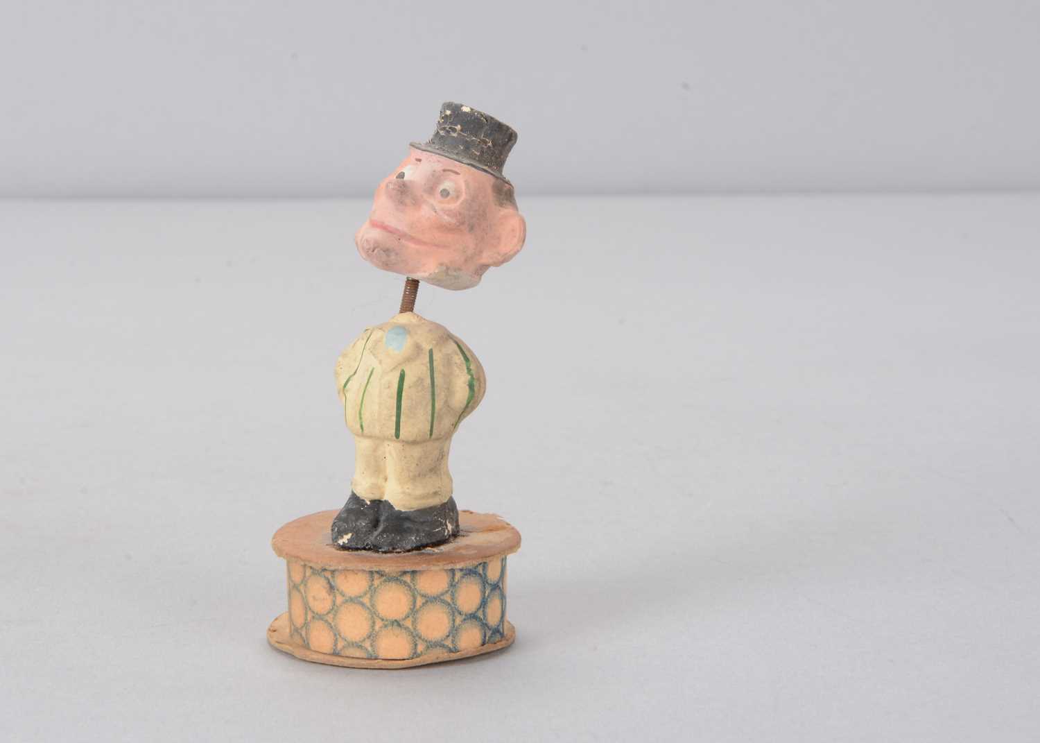 Lot 56 - A small early 20th century composition comic nodder candy or sweet box