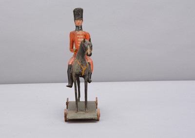 Lot 76 - A mid 19th century Thüringen composition and wood British mounted soldier pull along toy
