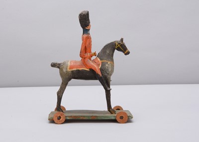 Lot 76 - A mid 19th century Thüringen composition and wood British mounted soldier pull along toy