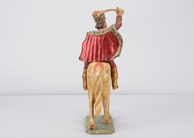 Lot 93 - A mid 19th century Germany carved wooden mounted red Hussar, possibly Oberammergau