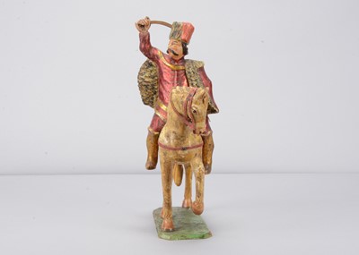 Lot 93 - A mid 19th century Germany carved wooden mounted red Hussar, possibly Oberammergau
