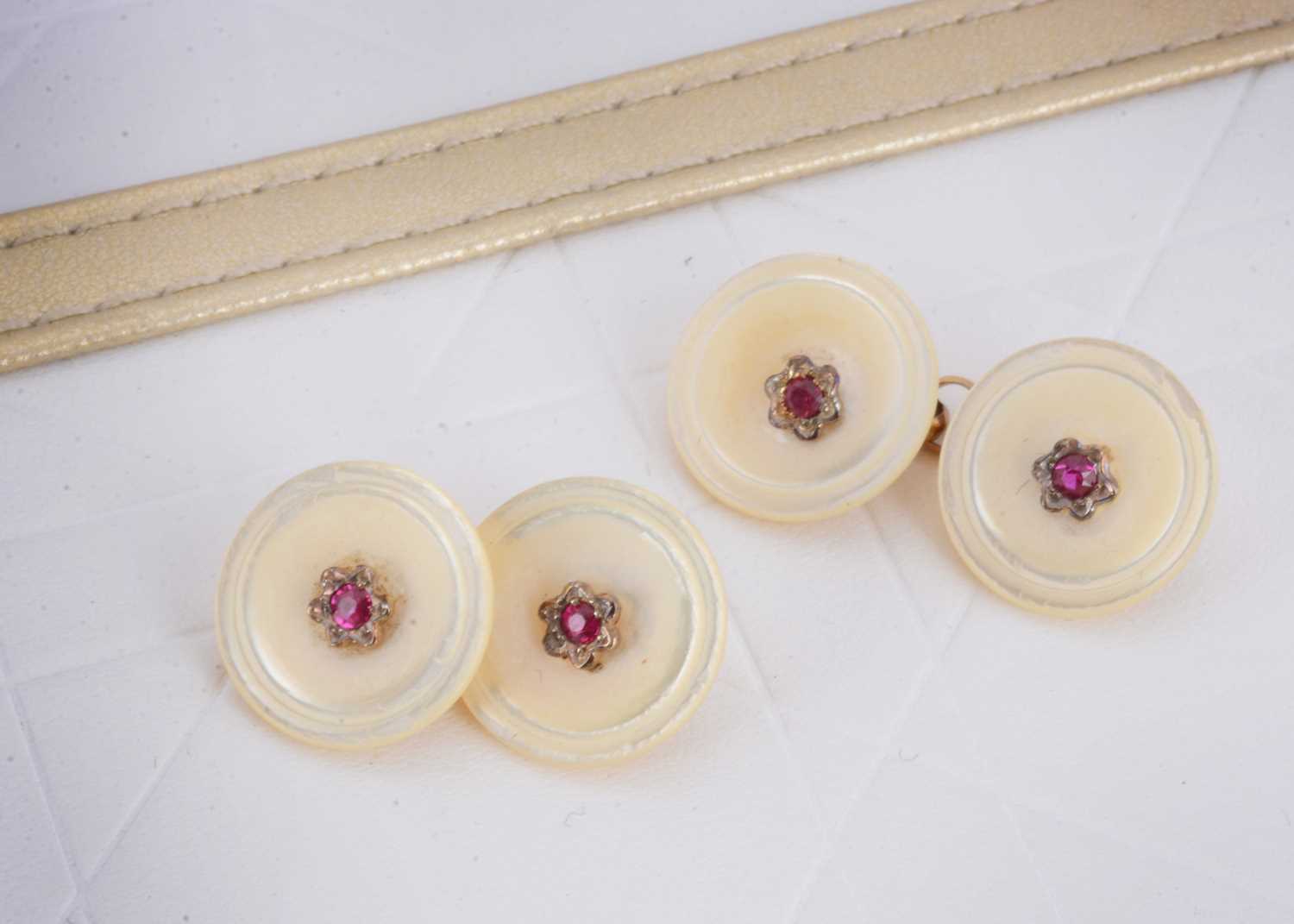 Lot 6 - A pair of mother of pearl and synthetic ruby button cufflinks
