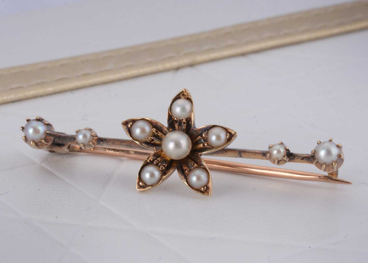 Lot 16 - An Edwardian gold and seed pearl bar brooch
