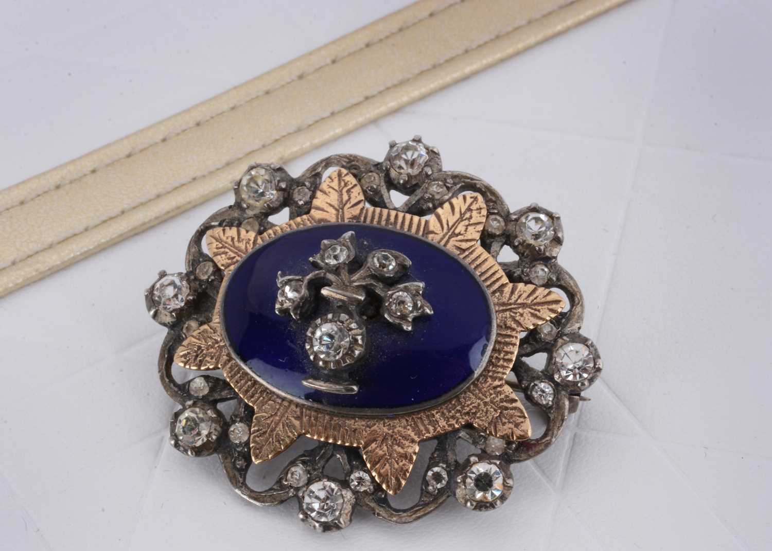 Lot 18 - A George VI silver, enamel and paste set oval brooch