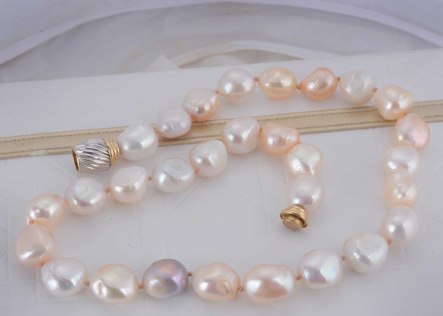 Lot 23 - A string of fireball cultured pearls