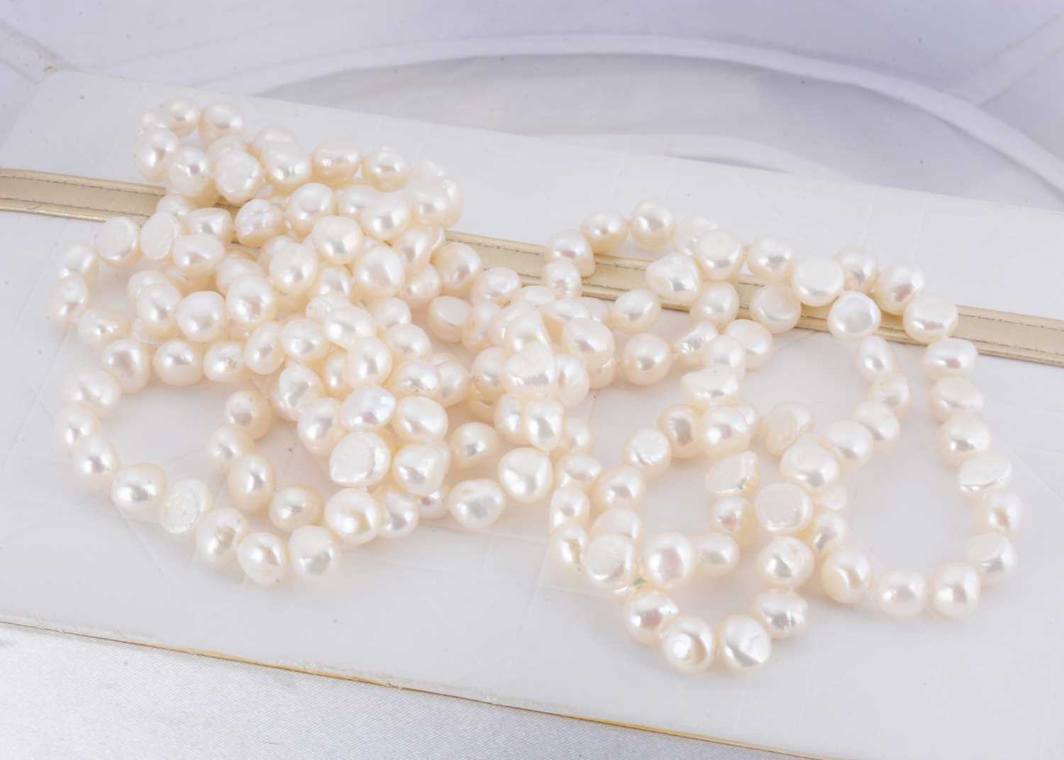 Lot 29 - An opera length string of freshwater knotted pearls