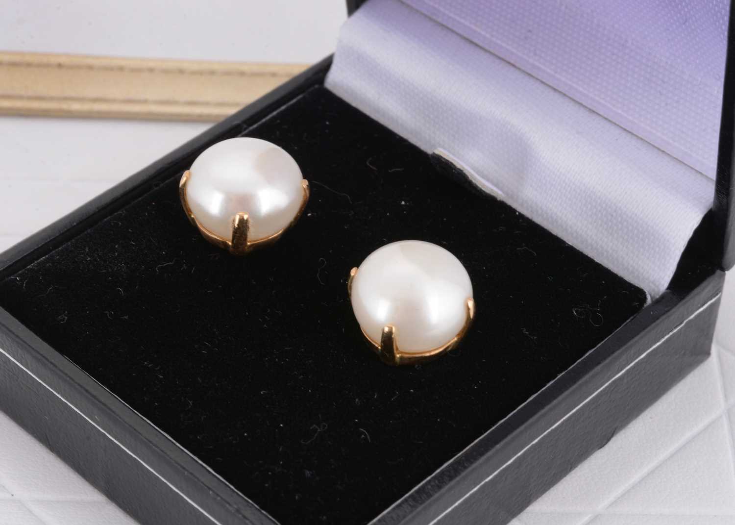Lot 32 - A pair of 18ct gold and large button pearl studs