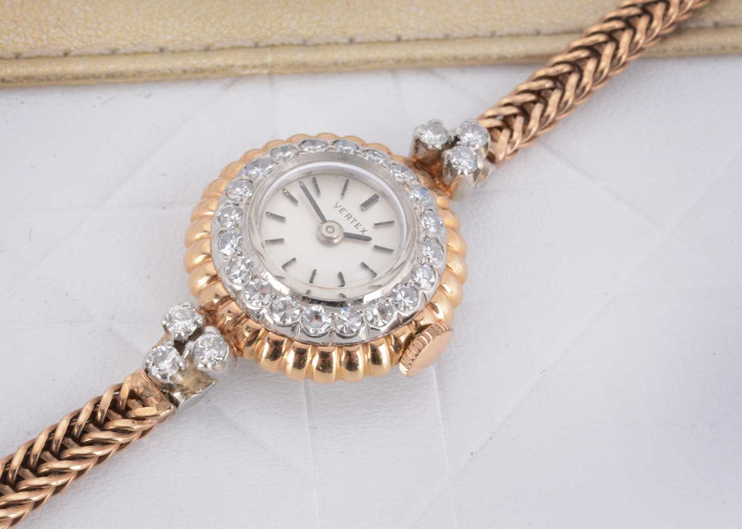 Lot 34 - A 9ct gold and platinum lady's circular diamond set Vertex cocktail watch