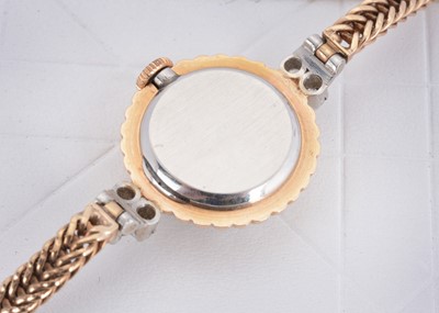 Lot 34 - A 9ct gold and platinum lady's circular diamond set Vertex cocktail watch