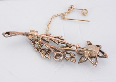 Lot 37 - An Edwardian diamond and pearl set flower head and stem brooch