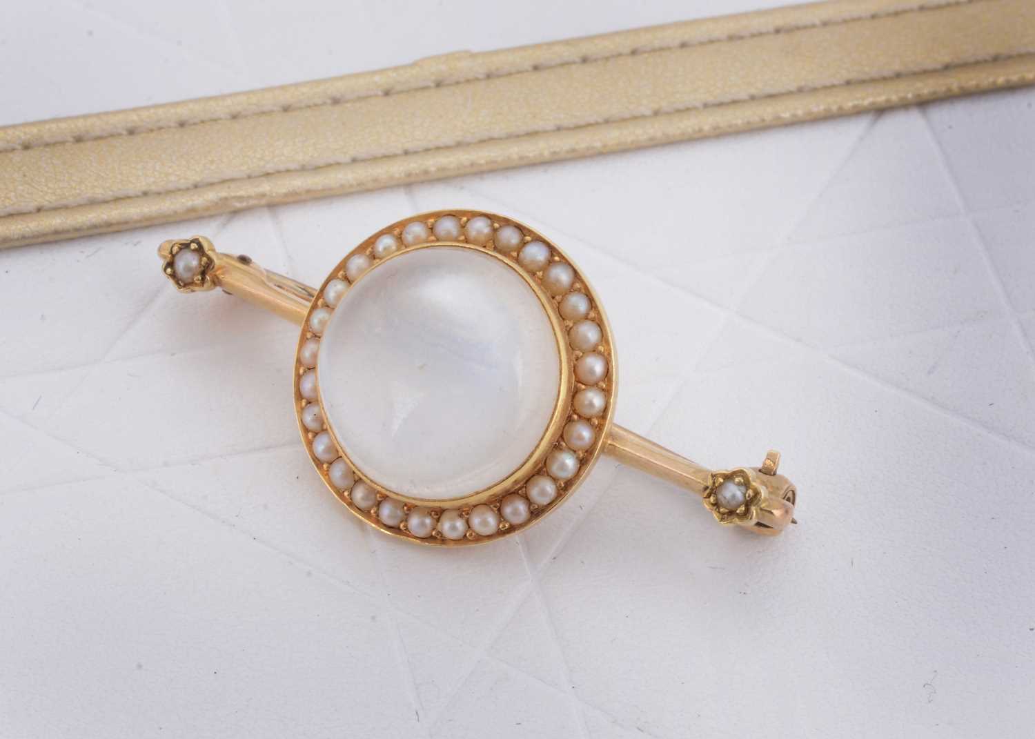 Lot 49 - An Edwardian moonstone and seed pearl bar brooch