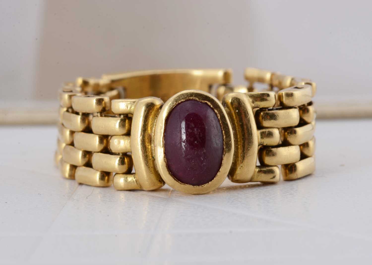 Lot 63 - An 18ct gold ruby chain ring