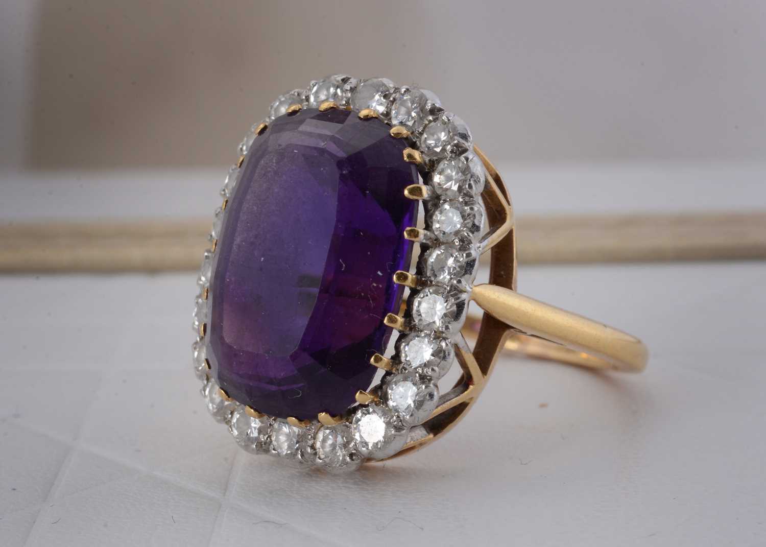 Lot 65 - An 18ct gold amethyst and diamond cluster ring