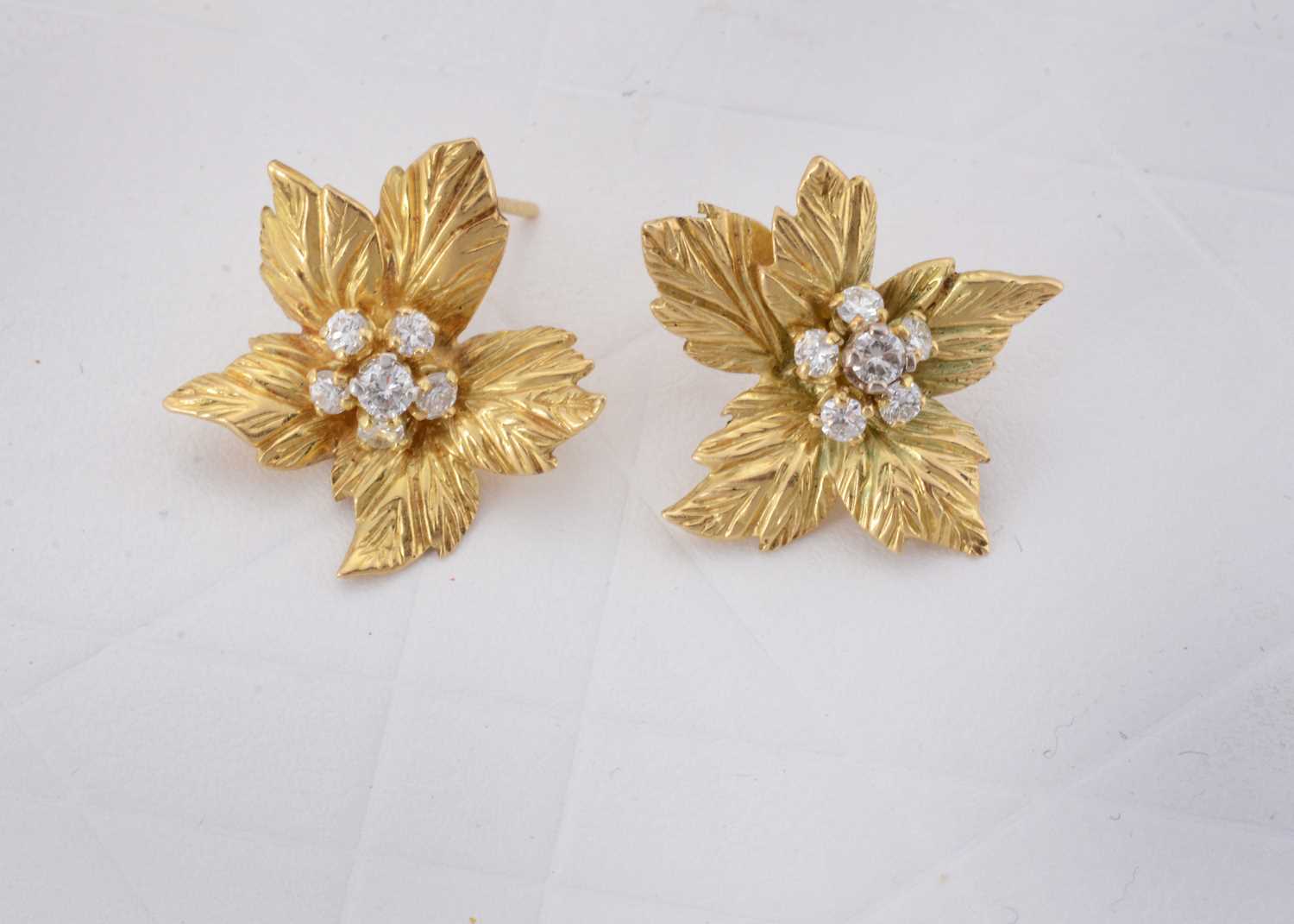 Lot 69 - A pair of Kutchinsky 18ct gold and diamond leaf earrings