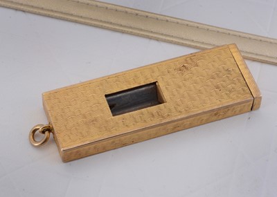 Lot 74 - A 9ct gold engine turned and sprung movement cigar cutter