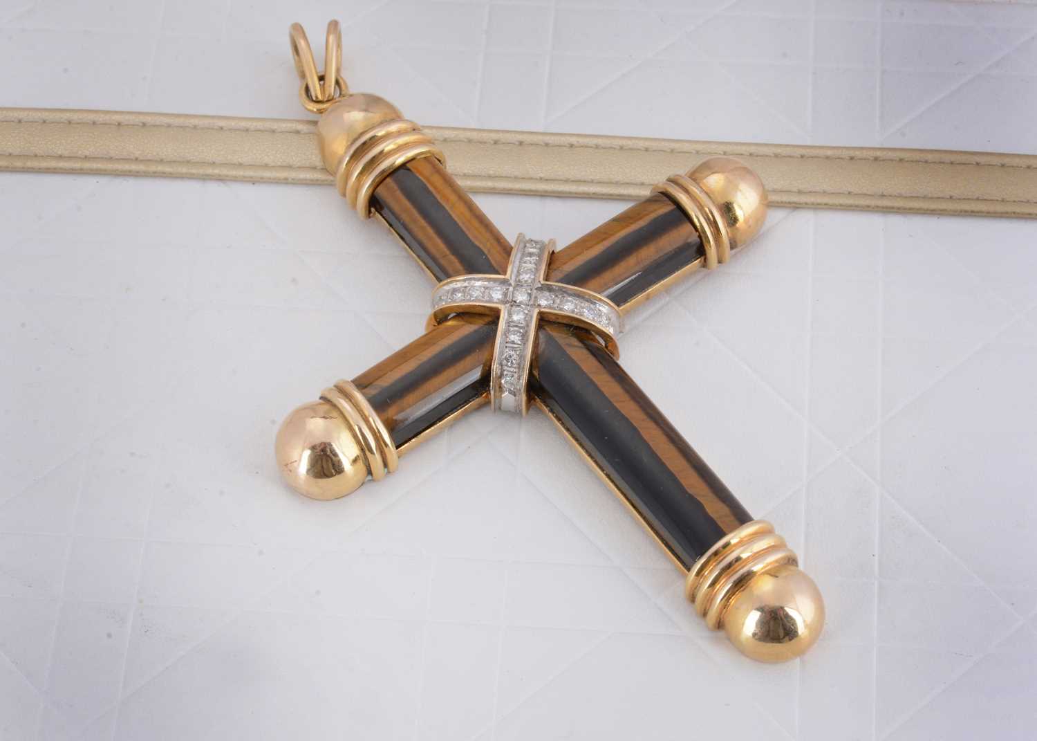 Lot 77 - A tiger's eye and 14ct gold diamond set cross pendant
