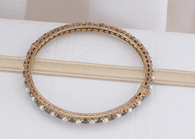 Lot 78 - An Indian emerald and pearl silver gilt hinged bangle