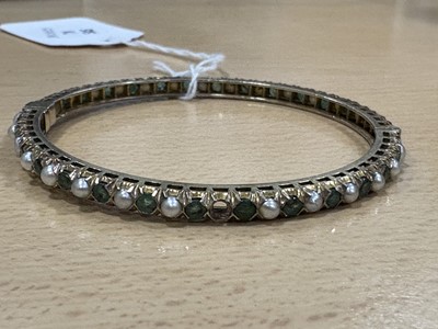 Lot 78 - An Indian emerald and pearl silver gilt hinged bangle