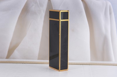 Lot 82 - A gold plated and black enamel rectangular Cartier pocket lighter