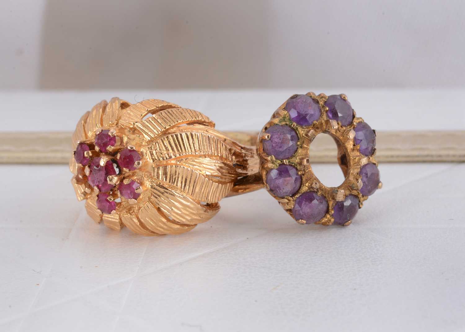 Lot 86 - A continental yellow metal and ruby set cluster ring