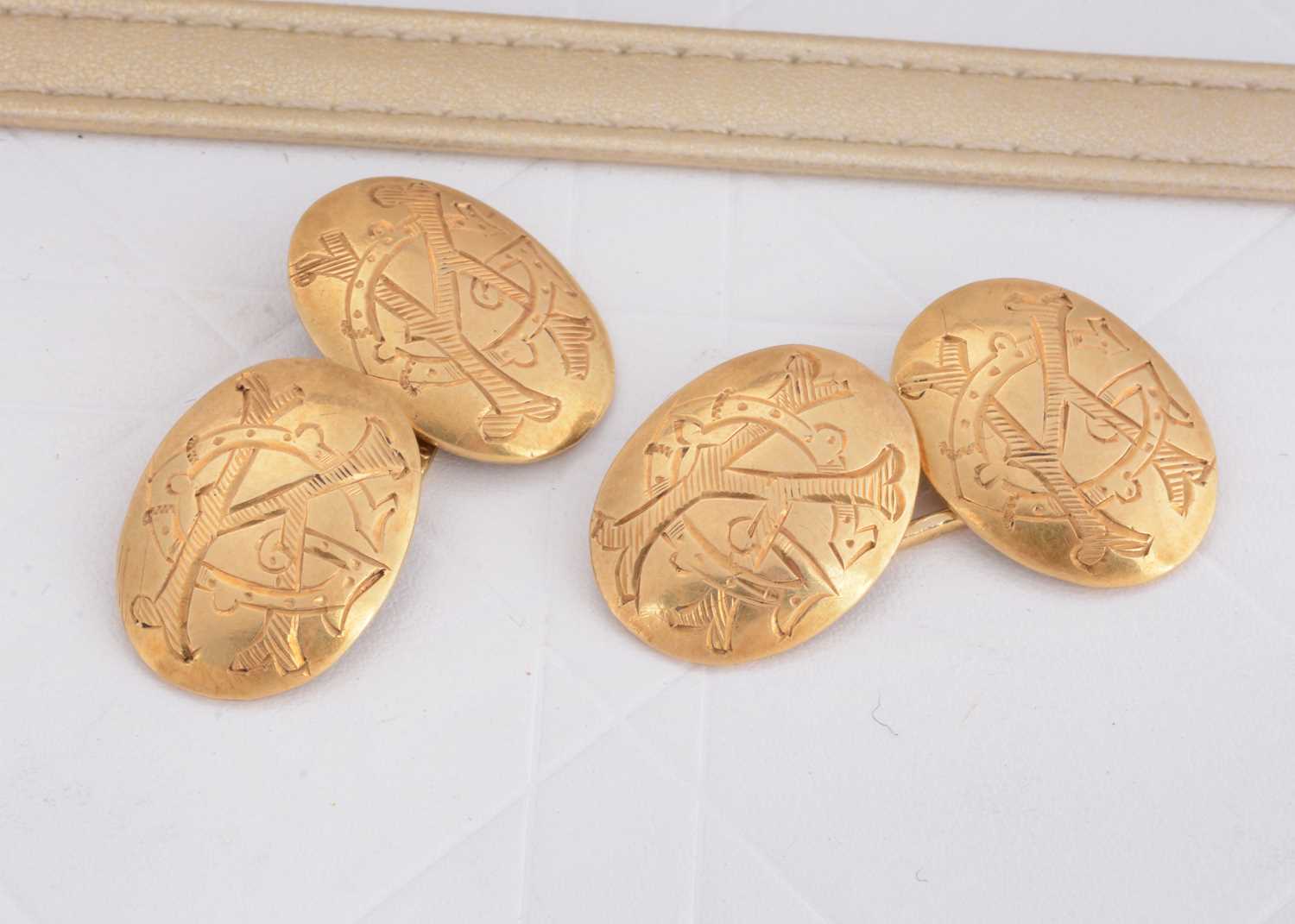 Lot 87 - A pair of 18ct gold oval cufflinks united by a large oval link