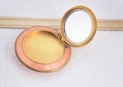 Lot 104 - An Edwardian gilt metal and guilloche enamel circular locket