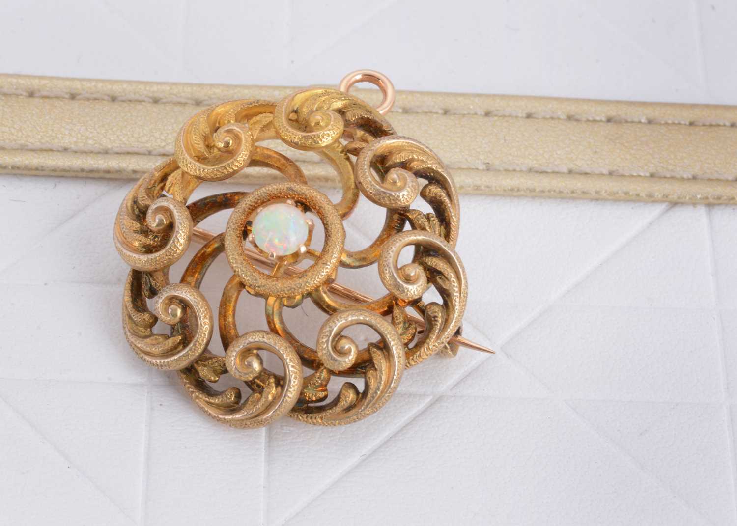 Lot 116 - An Edwardian openwork circular scroll target brooch or pendant