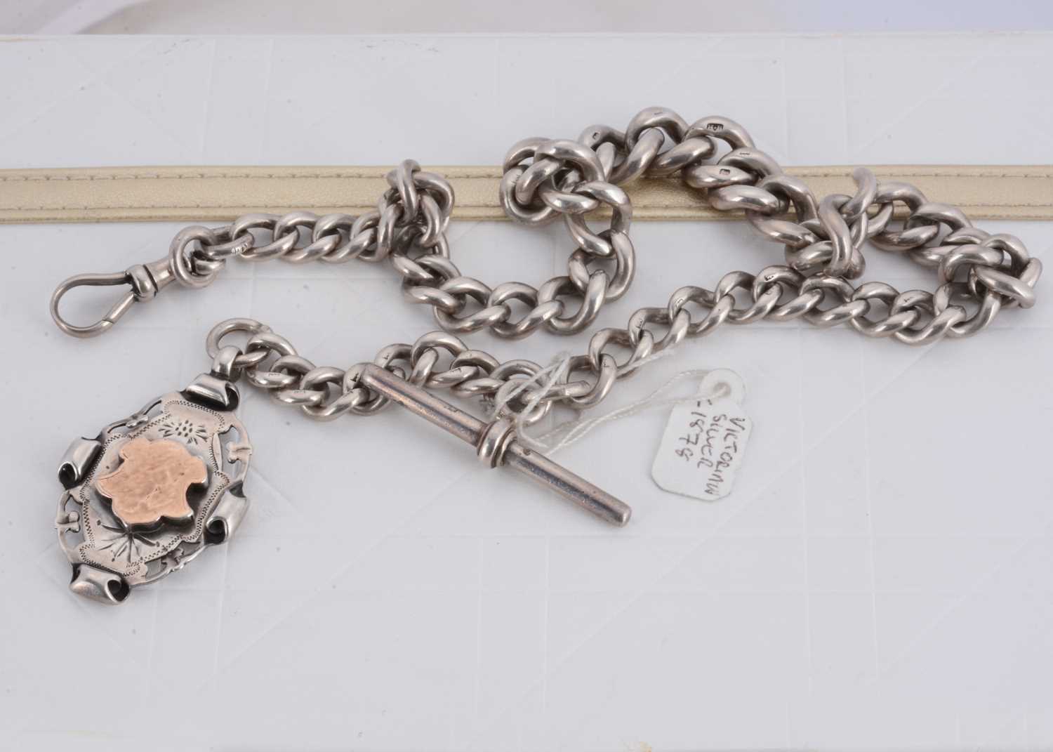 Lot 131 - A Victorian silver curb link graduated watch chain and fob medallion