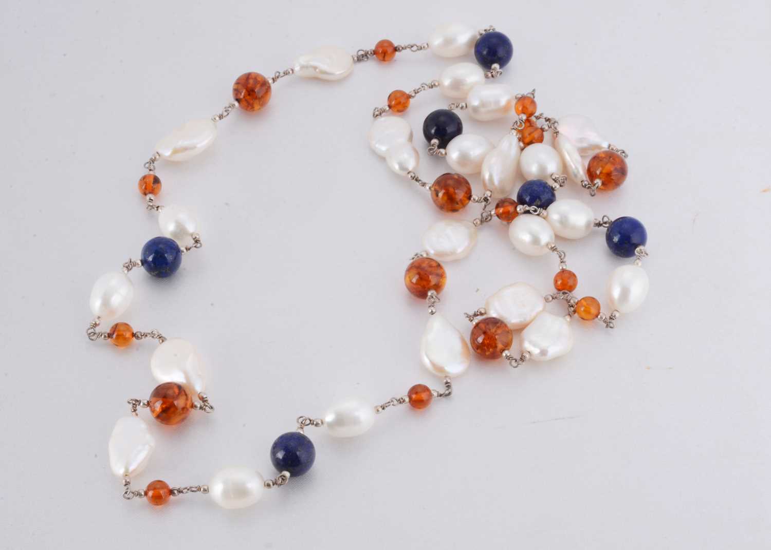 Lot 132 - A contemporary freshwater pearl, amber and lapis lazuli necklace