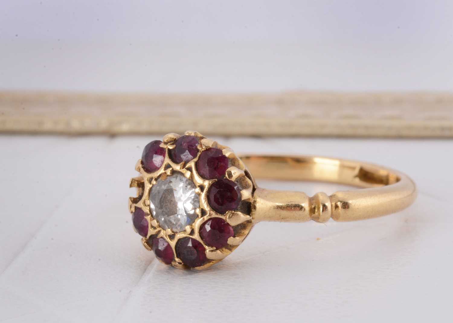 Lot 138 - An 18ct diamond and ruby cluster ring