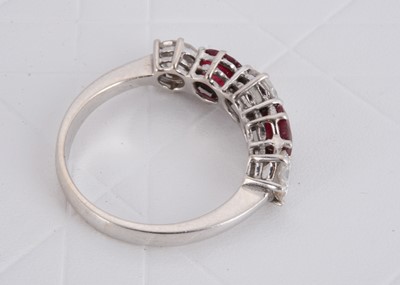 Lot 152 - A ruby and diamond five stone white metal dress ring