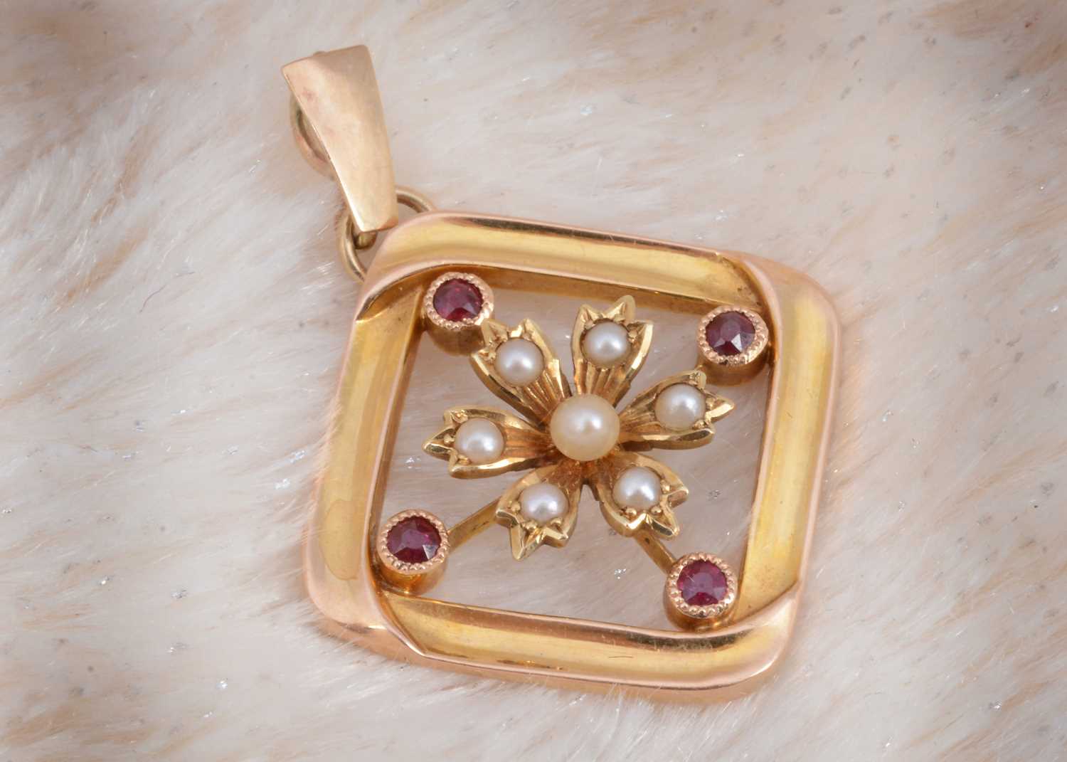 Lot 11 - A 15ct gold ruby and seed pearl drop pendant