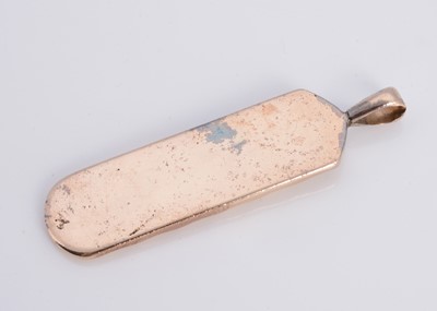 Lot 8 - A yellow metal ingot shaped pendant