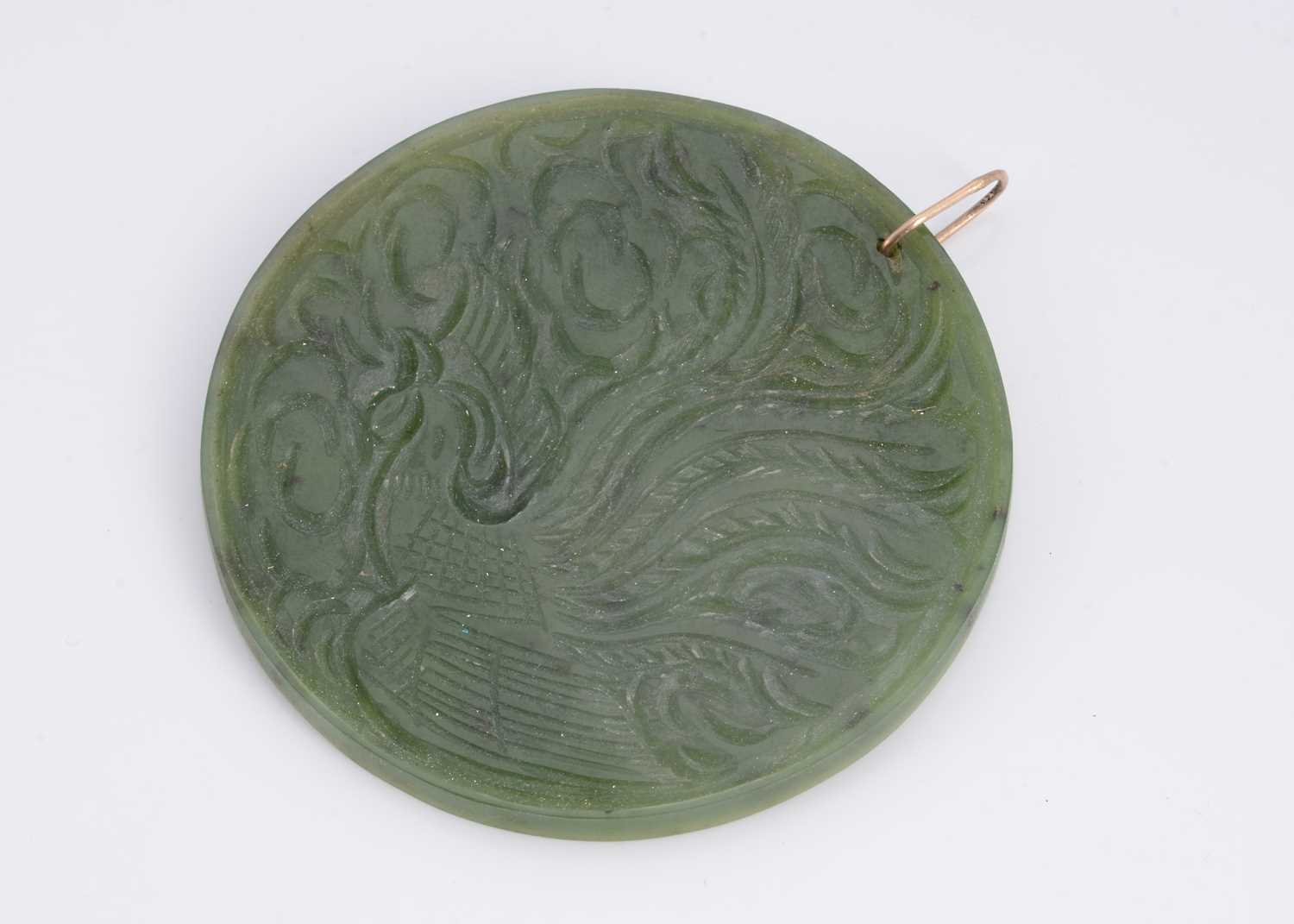 Lot 26 - A nephrite jade double sided carved medallion pendant