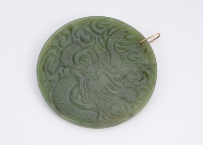 Lot 26 - A nephrite jade double sided carved medallion pendant