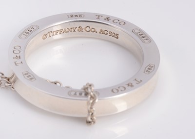 Lot 64 - A silver Tiffany & Co circle band pendant necklace, in turquoise box marked Tiffany & Co