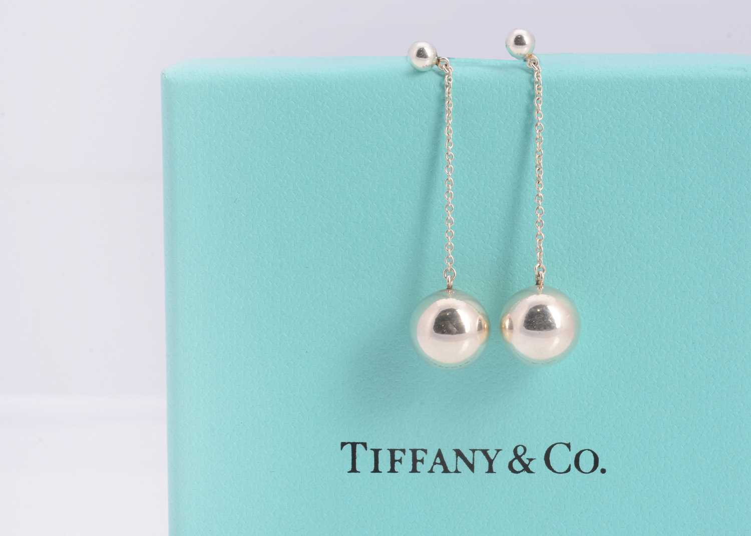 Lot 65 - A pair of silver Tiffany & Co stud, chain & ball drop earrings, in turquoise box marked Tiffany & Co