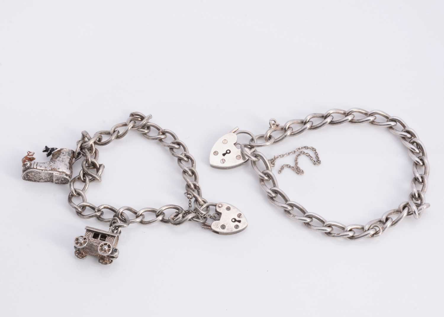 Lot 68 - A silver curb bracelets with padlocks