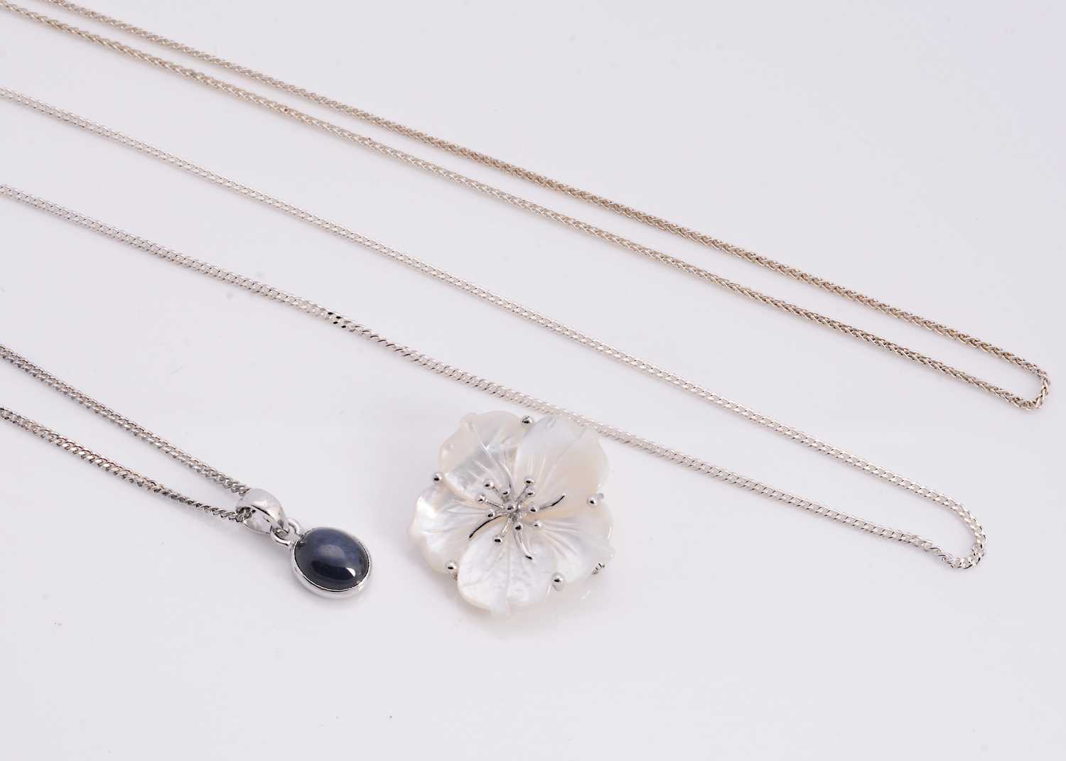 Lot 71 - A synthetic star sapphire silver pendant necklace, mother of pearl flower brooch with pendant bail