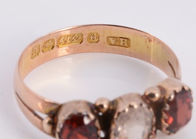 Lot 84 - A 9ct rose gold three stone garnet dress ring
