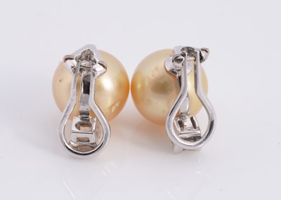 Lot 93 - A pair of golden south sea pearl & diamond earrings