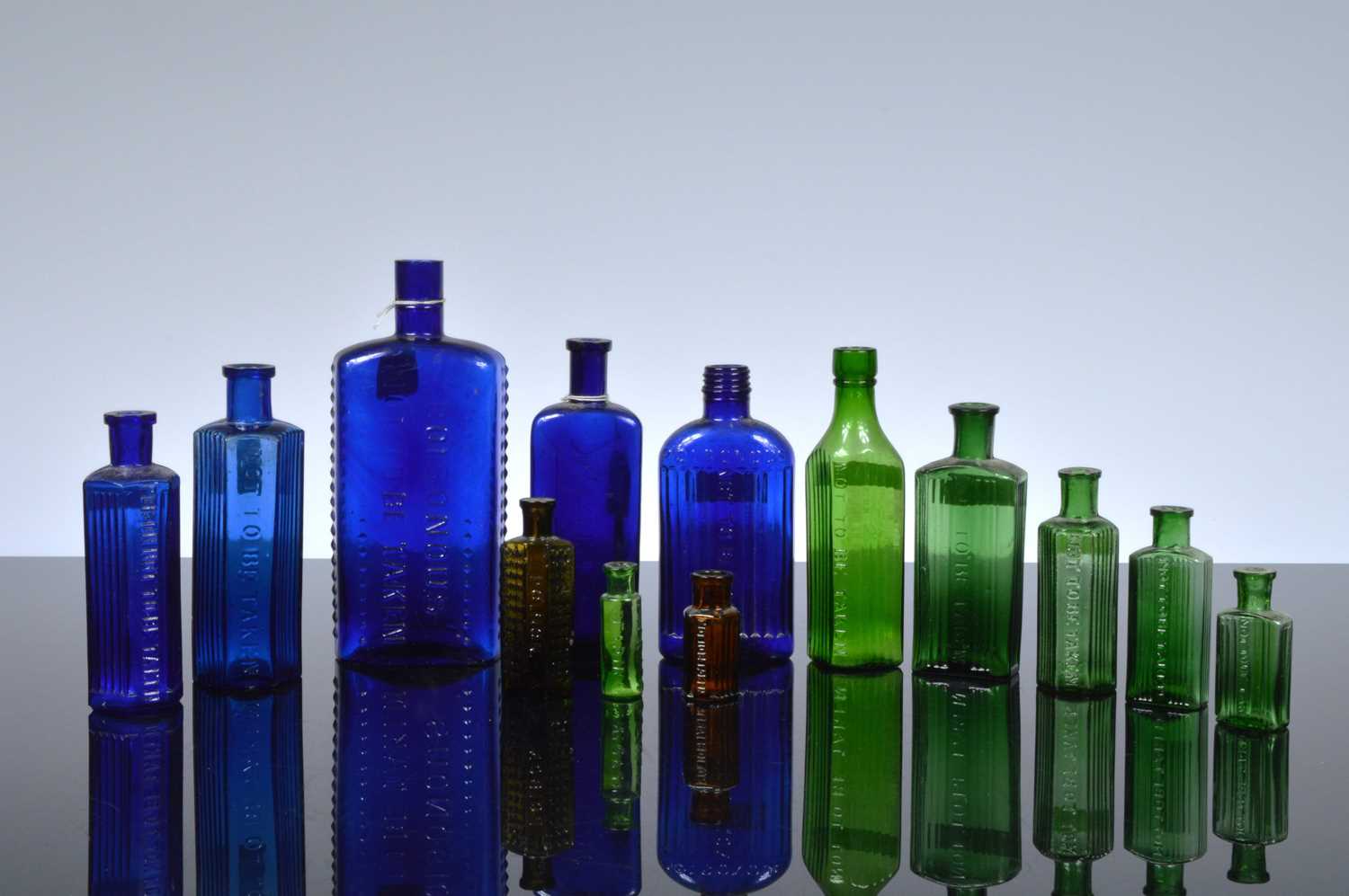Lot 24 - A collection of thirteen poison and other toxic liquid bottles