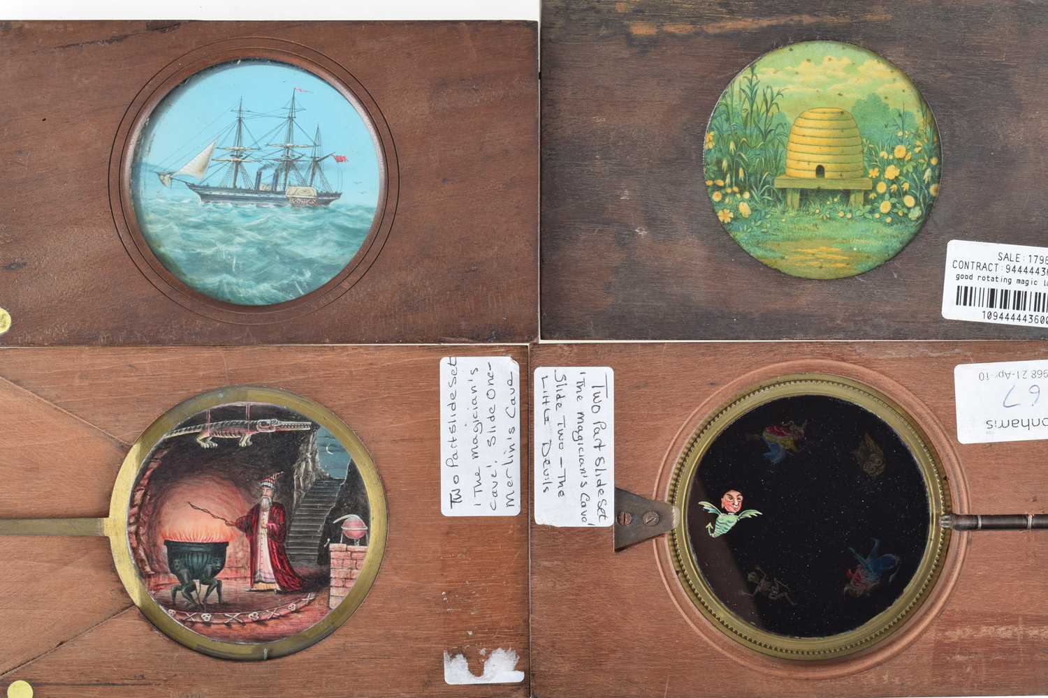 Lot 23 - Four Mahogany Mounted Hand Cranked Rotary and one lever Magic Lantern Slides